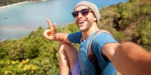man taking selfie with peace sign