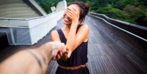 woman blushing holding hands