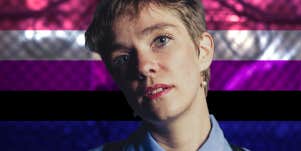 genderfluid person with flag behind them