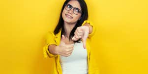 young brunette woman with thumbs up and thumbs down