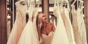 woman in between wedding dresses