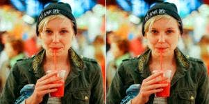 woman in a beanie drinking a smoothie