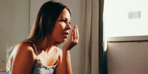woman smelling her breath