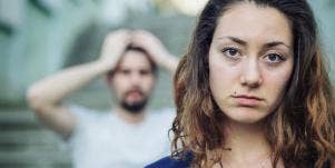 upset woman with distressed man behind her