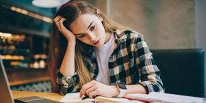 tired woman working at her desk dreaming about a new job
