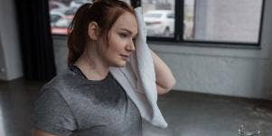 sweaty woman toweling herself off
