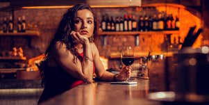 single woman sitting alone at bar
