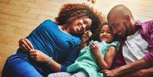 mother and father playing with daughter