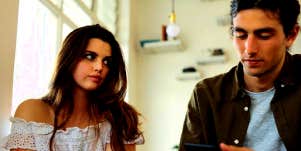 woman looking disappointed with guy who isn't making an effort