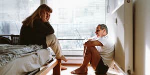 unhappy couple sitting in bedroom
