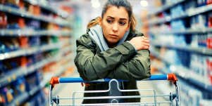 woman looking sad because she doesn't feel loved while she walks through the grocery store