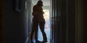 man and woman hugging in hallway