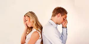 couple facing at opposite direction looking nervously