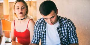 woman sitting next to man who is pulling away