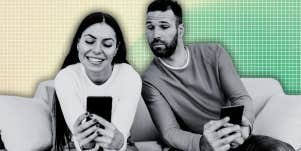 Man looking over woman’s shoulder at her phone 