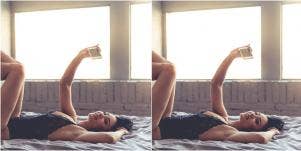 woman in lingerie taking a selfie in bed