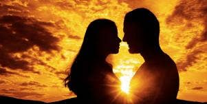 woman and man embracing in sunset