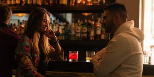 man and woman sitting at bar