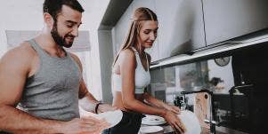man and wife cooking together in kitchen