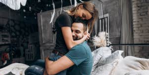 couple cuddling in a sweet way, she hugs his head and he hugs her waist
