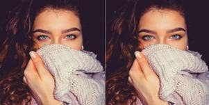 woman covering her mouth with sweater