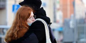 Woman being hugged by partner