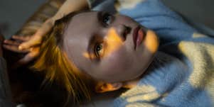 woman thinking while laying in bed