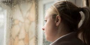 Woman looking out window