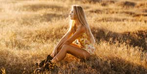 Woman sitting in sunset