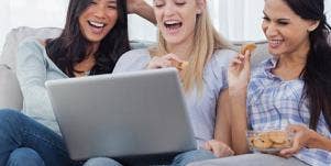 women laughing at laptop