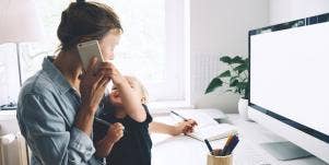 mother working at computer with toddler