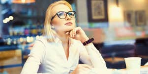 Thoughtful woman working in coffee shop