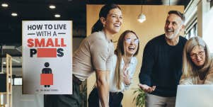 Man surrounded by female coworkers, gag gift