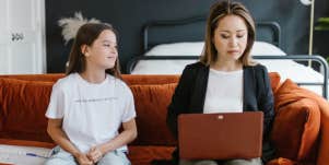 Working mom on a couch with her daughter