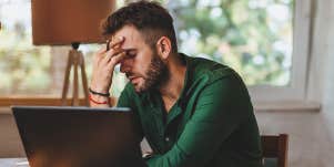 stressed man working at laptop