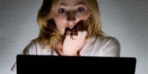 scared woman looking at computer
