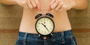 clock over woman's stomach