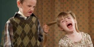 boy pulling girl's hair