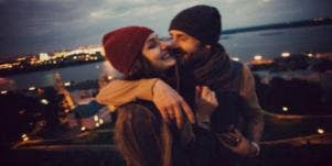 couple standing in front of city lights