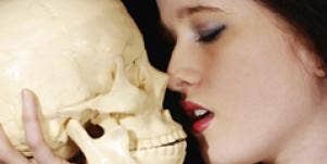 woman kissing skull