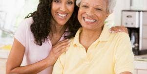 adult daughter with elderly mother smiling