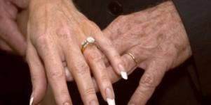 older hands with wedding ring