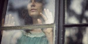 woman looking out of window
