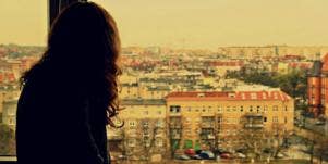 woman staring out of her window