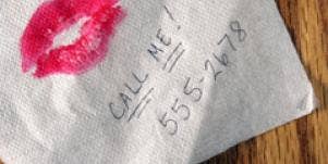 Lipstick and phone number on napkin