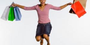 woman jumping with shopping bags