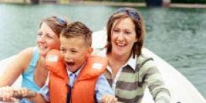 two women with young boy in rowboat