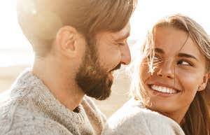 man looking loving at woman at the beach smiling