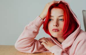 depressed woman peering out 
