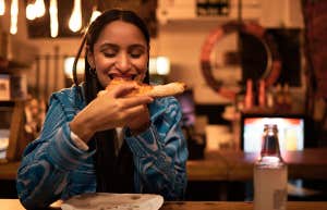 Happy and satisfied foodie having tasty supper at a diner